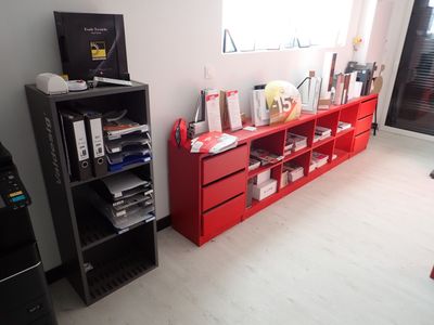 une pièce équipée d'une télévision, d'une bibliothèque et d'une imprimante