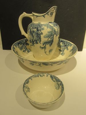 a blue and white bowl and a pitcher on a table