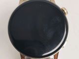 a close up of a smart watch on a white surface