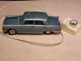 a toy car connected to a telephone on a table