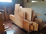 several pieces of wood are stacked on top of each other in a warehouse