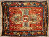 a close up of a red and blue rug with a cross on it
