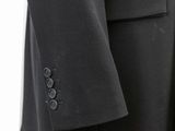a close up of a suit on a hanger on a white background