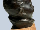 statue of a child ' s head on a marble block