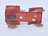 a red toy train that is sitting on a white surface
