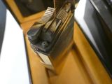 a black and gold case with a lighter inside of it