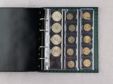 a black binder with a bunch of coins in it