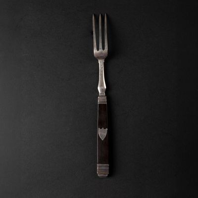 a fork with a heart on it on a black background