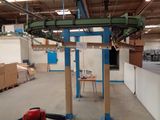 a picture of a factory with a conveyor belt in the middle of the room