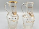 pair of clear glass vases with gold rims on a white surface