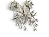 an image of a silver broochle with flowers and leaves