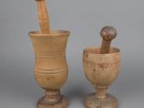 pair of wooden mortar and pest grinds on a gray background