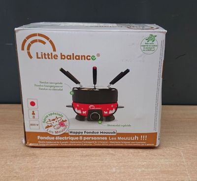 a box with a little balance on it sitting on a table