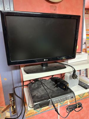 a flat screen tv sitting on top of a desk