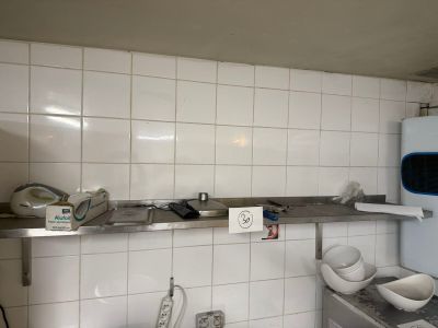 a small kitchen with a refrigerator and a sink