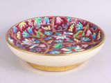 a bowl with a floral design on it sitting on a table