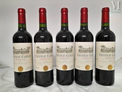 four bottles of red wine are lined up on a table