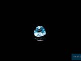 a close up of a blue topaz diamond on a black surface
