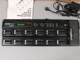 a picture of an electronic keyboard and a charger on a table