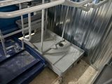 a picture of a hospital room with a cart and a chair