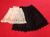 two black and white lace skirts on a red background