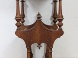 an old wooden table with a shelf on top of it