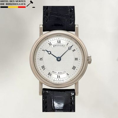 a silver wrist watch with roman numerals on the face