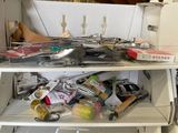 a white shelf with a bunch of kitchen utensils on it