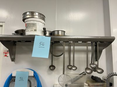 a shelf that has a lot of cooking utensils on it