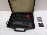 a black case with a black cord and a red button