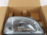 an image of a car headlight in a cardboard box on a white surface