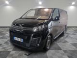 the black van is parked in a large room with a checkered floor