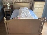 a bed that is in a room with a stone wall