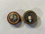 two miniature portraits of a man and a woman on a table
