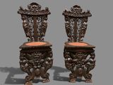 pair of antique carved wooden chairs with upholstered seats