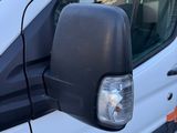 a white van parked in a parking lot next to a building