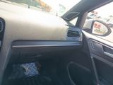 a dashboard of a car with a view of a parking lot in the background