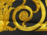 gold and black scarf with a design of a dragon and a flower