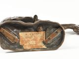 bronze statue of a horse with a tag on it ' s back