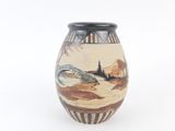 a vase with a painting on it sitting on a table
