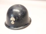 a helmet with a cross on it sitting on a table