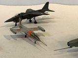 four model airplanes that are on display on a table