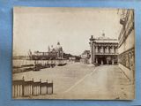 an old photo of a street with a building in the background