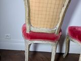two chairs sitting next to each other on a hard wood floor