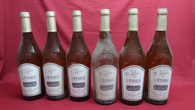 six bottles of wine are lined up in a row on a pink background