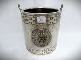 a silver cup with a medallion on it