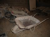 a dirty wheelbarrow in the middle of a dirty room