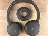 a pair of headphones sitting on top of a wooden table