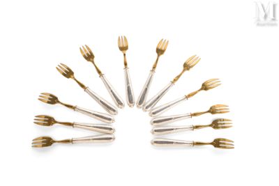 several forks and spoons arranged in a circle on a white surface