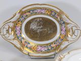 a bowl and a plate sitting on a table next to each other